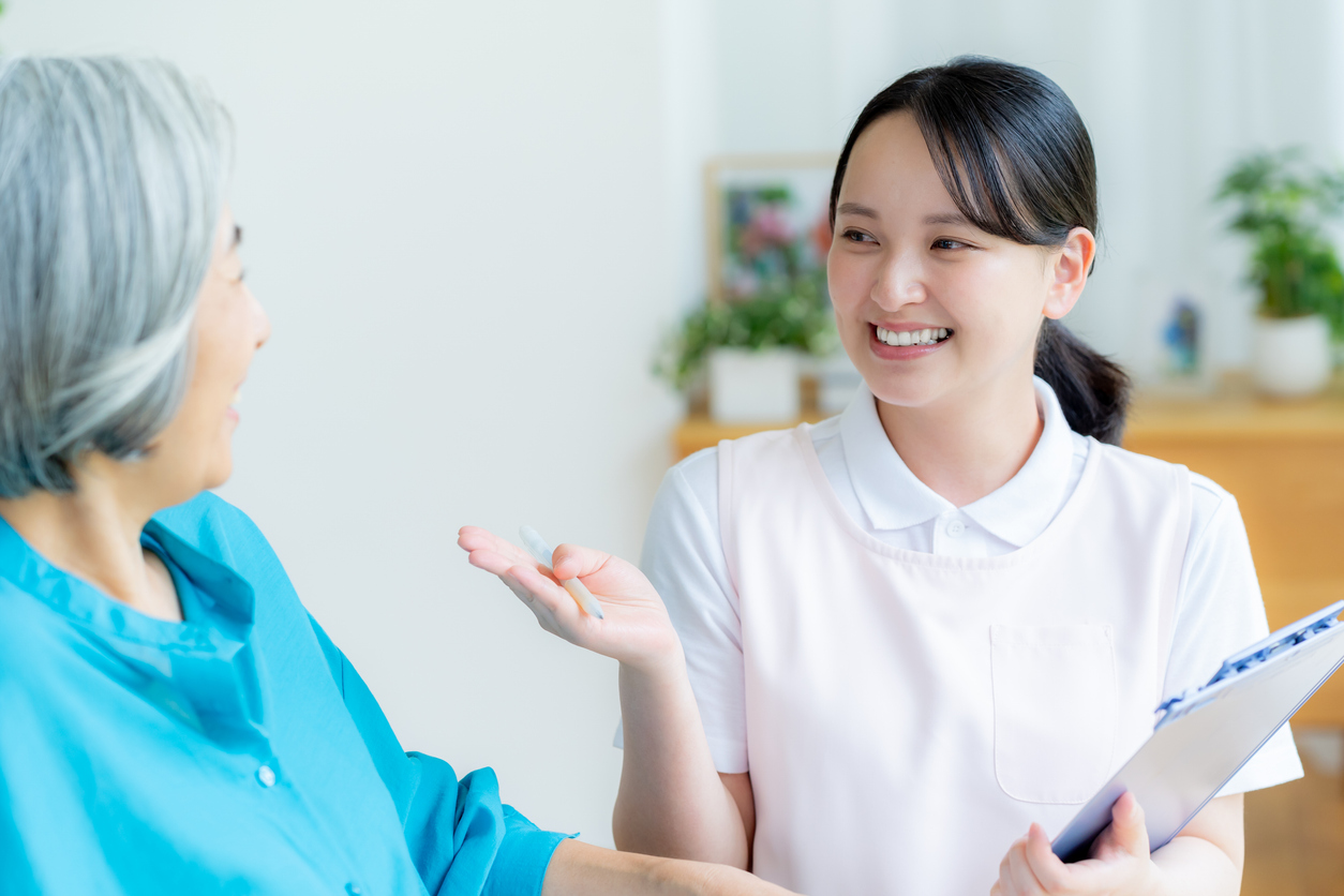 Caregiver supporting a woman in a wheelchair